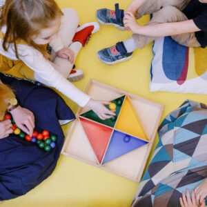 Kids engaged in playful learning with colorful toys in a vibrant playroom setting.